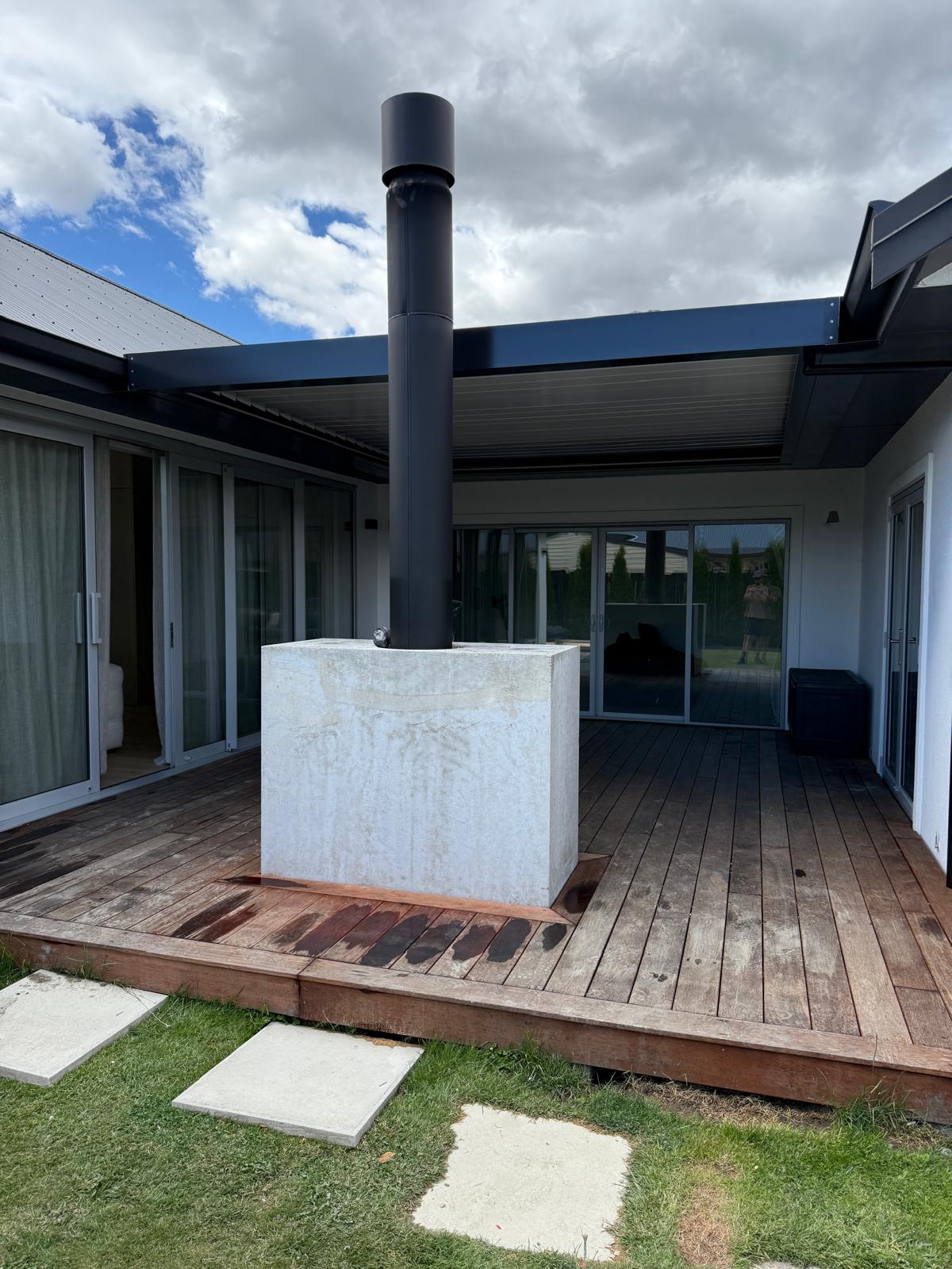 Louvre roof over a deck with a flue running through it in Central Otago
