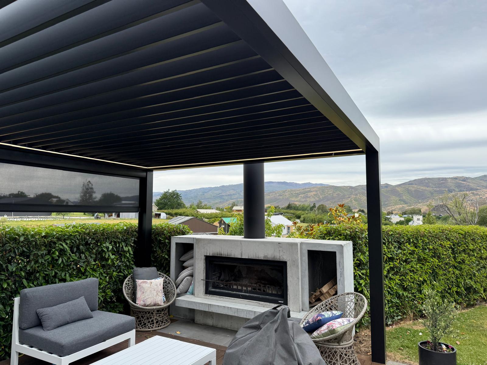 Underside of a black louvre roof with LED strip lighting and mountain views in Central Otago