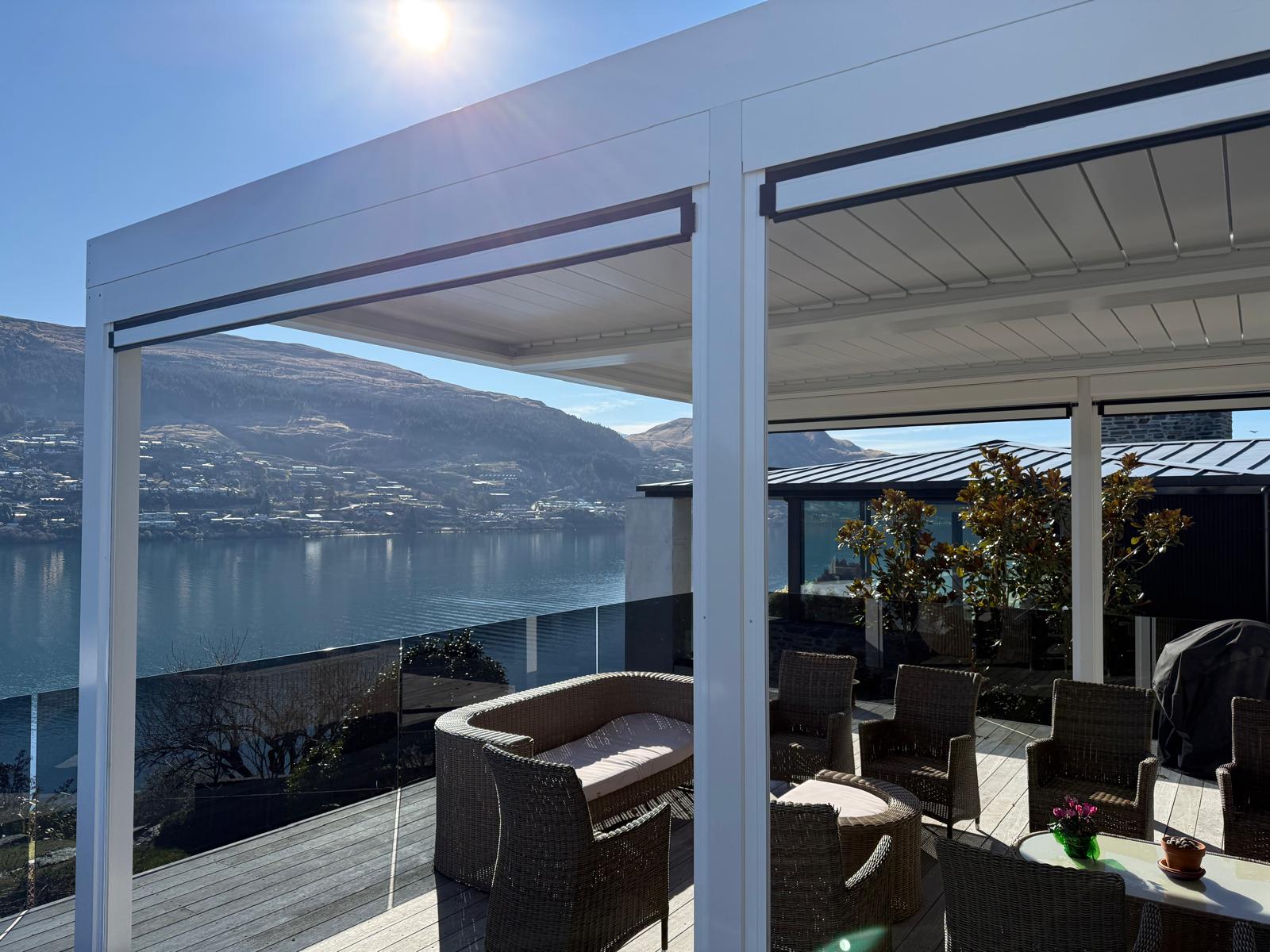 White louvre roof with outdoor blinds overlooking Lake Wakatipu in Queenstown