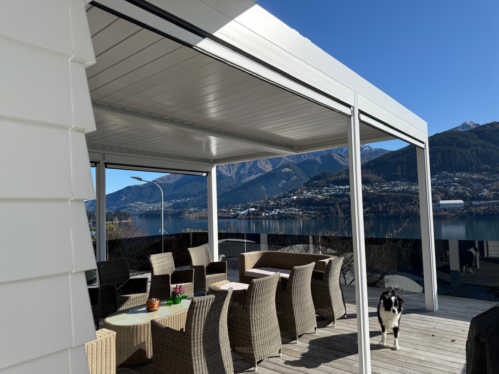 White louvre roof over a lakeside deck with Lake Wakatipu views in Queenstown