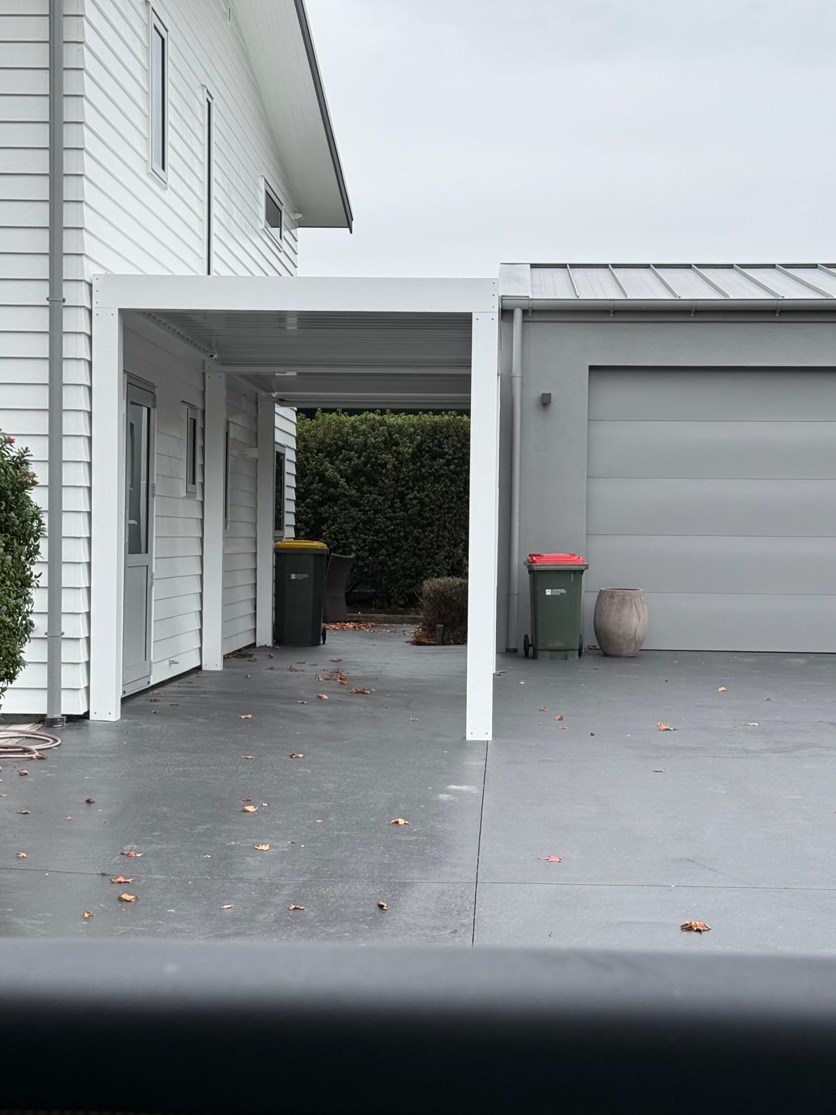 White louvre roof over a side path between house and garage in Queenstown
