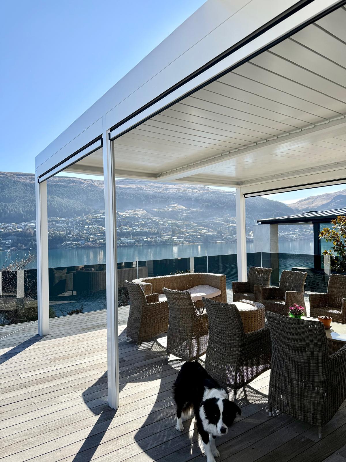 White louvre roof over a deck with a Border Collie in Queenstown